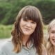 Two women smiling outdoors.