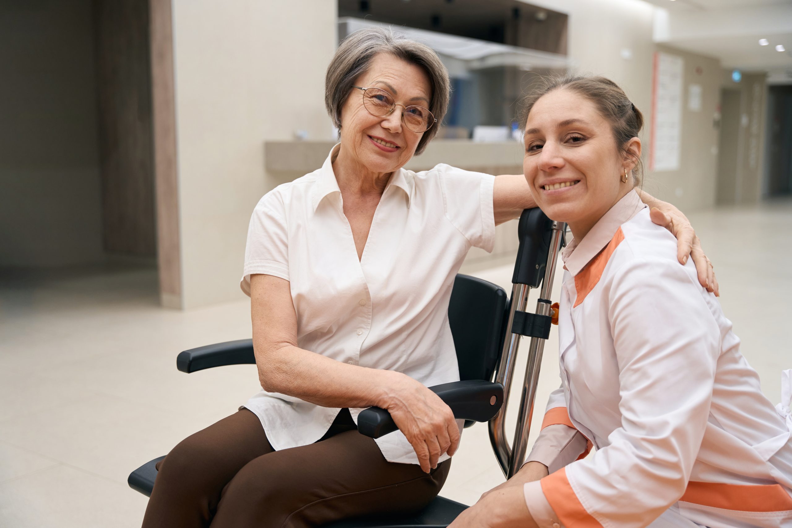 Support worker providing emotional and practical support to NDIS participant in wheelchair