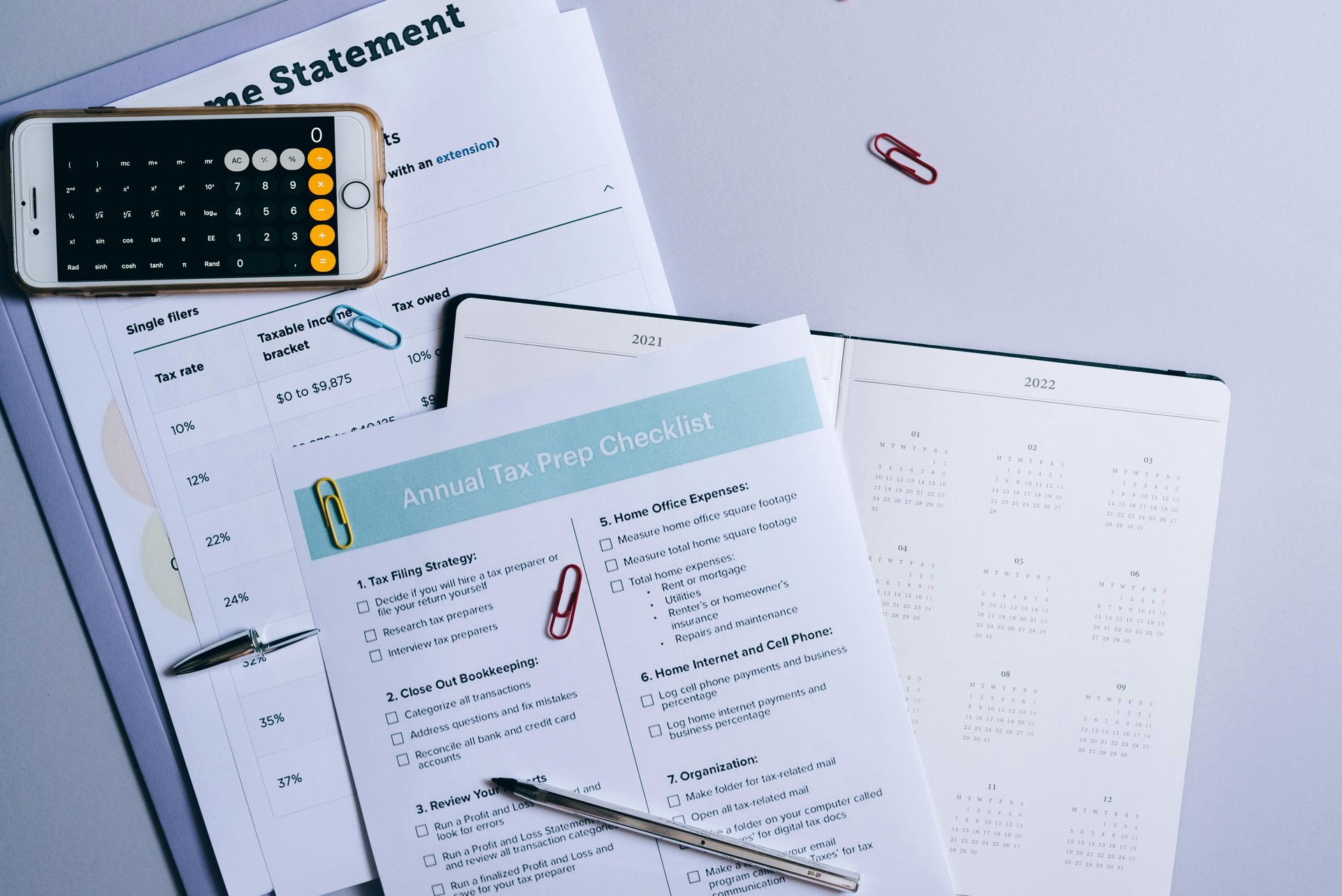 Flat lay of aged care audit preparation checklist, calculator, and compliance documents on desk