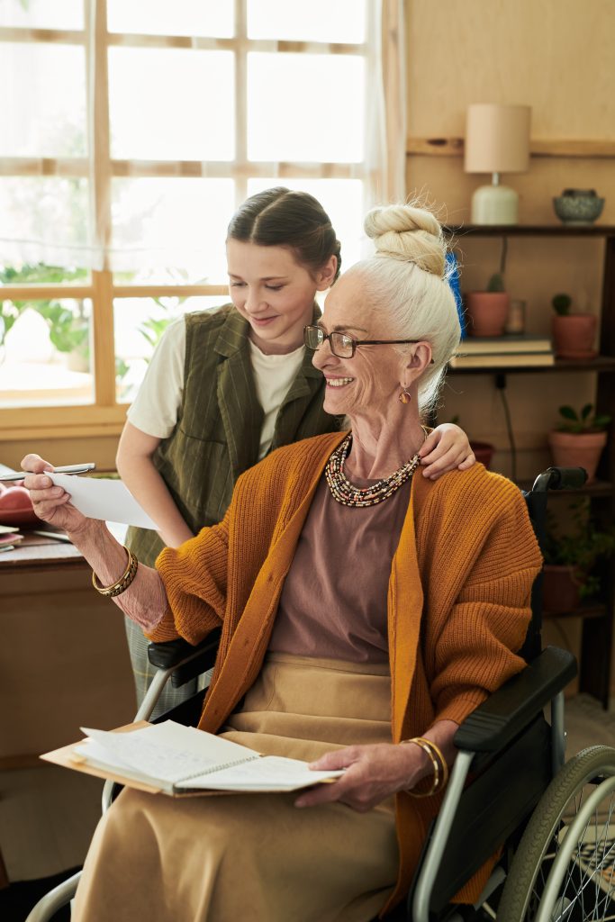 Assisting elderly woman in wheelchair