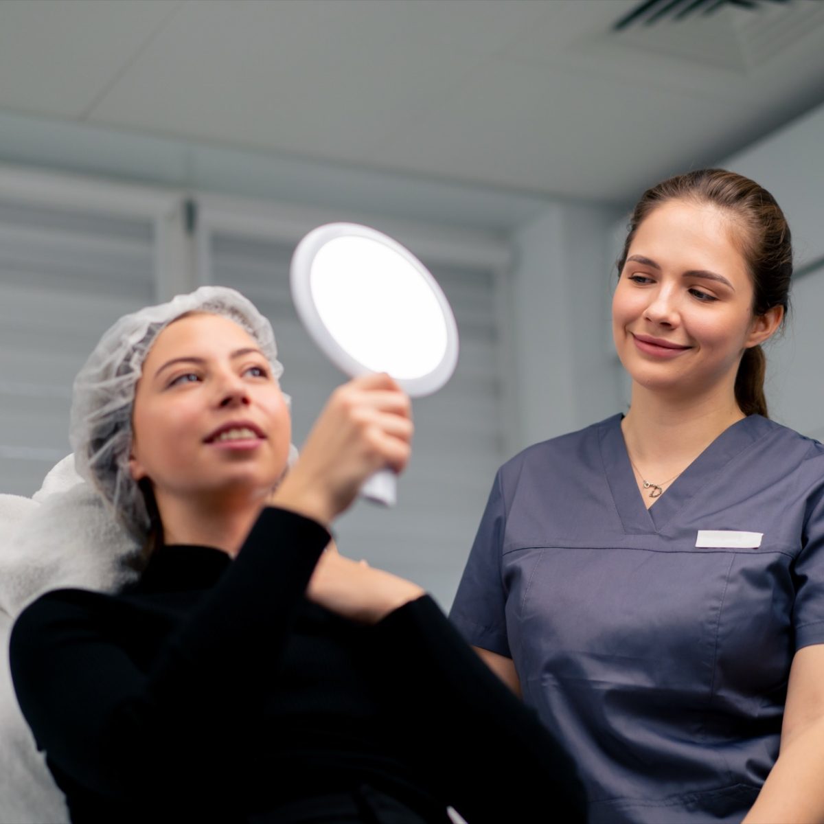 Client reviewing treatment results with cosmetic consultant in clinic