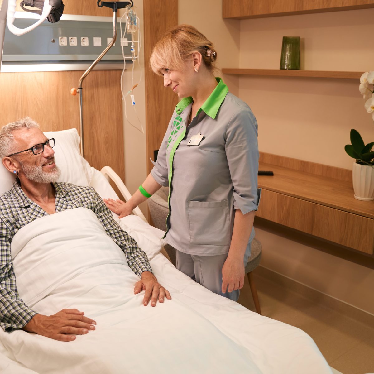 Healthcare professional implementing aged care policies and procedures with elderly patient