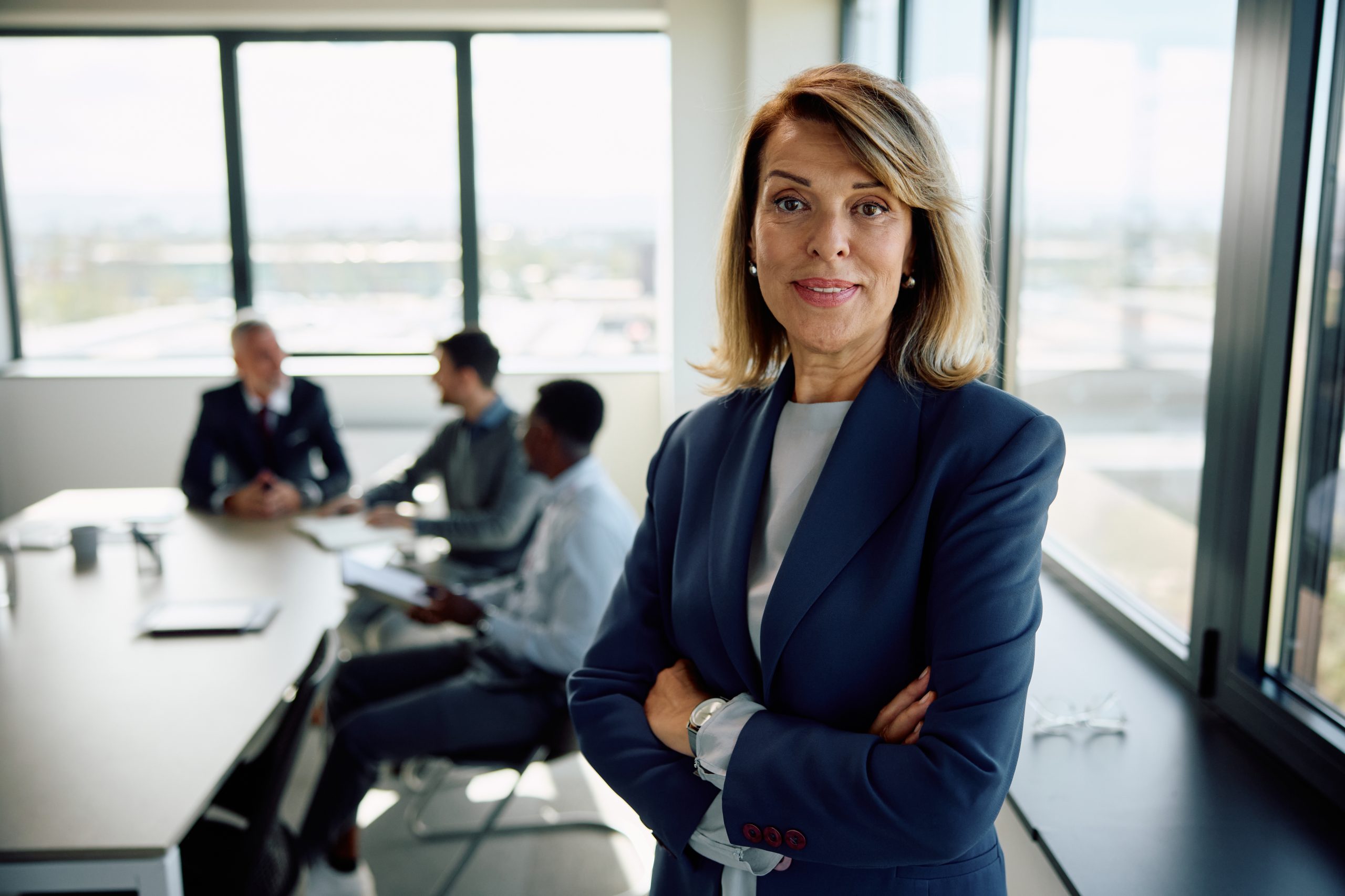 Female business compliance consultant reviewing NDIS registration renewal documentation