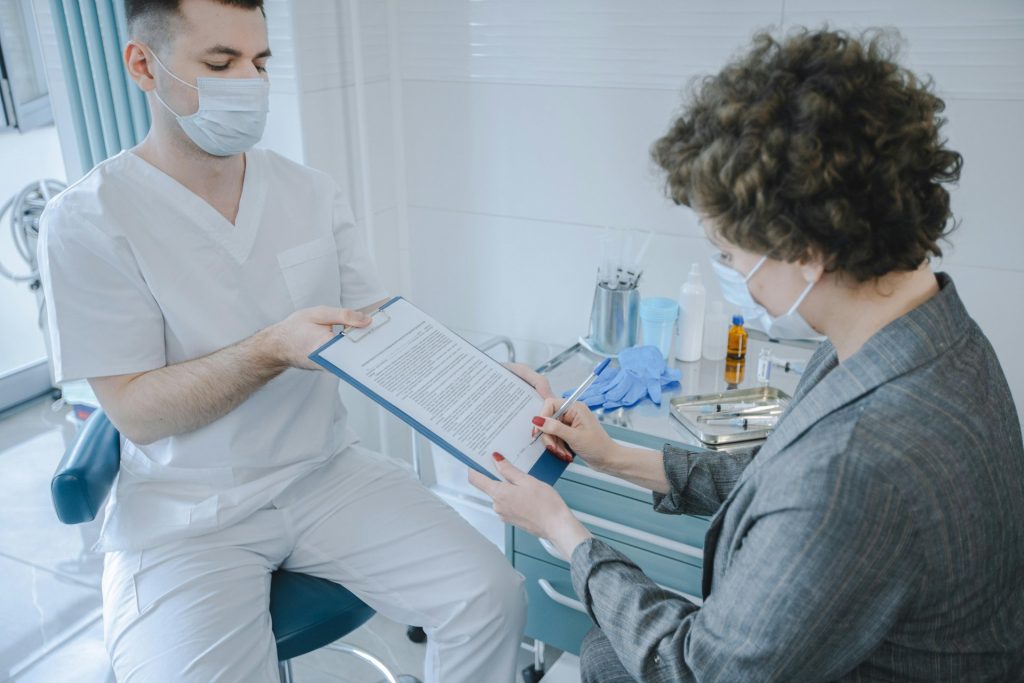 Medical professional reviewing insurance documentation with cosmetic clinic operator