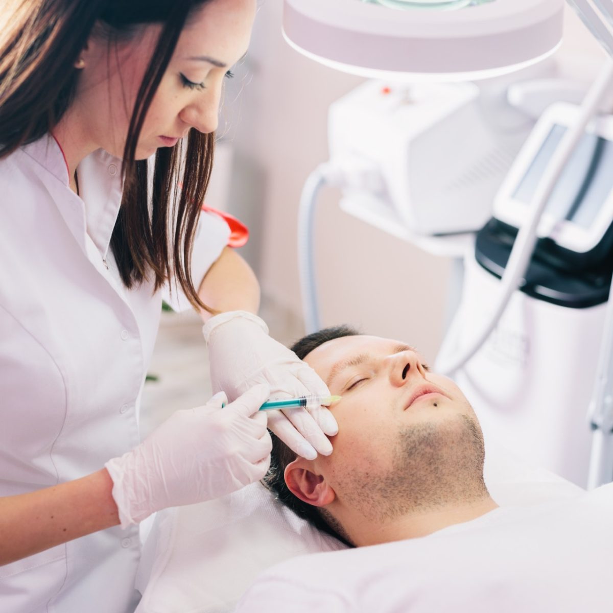 Male client receiving injectable cosmetic treatment in a professional clinic