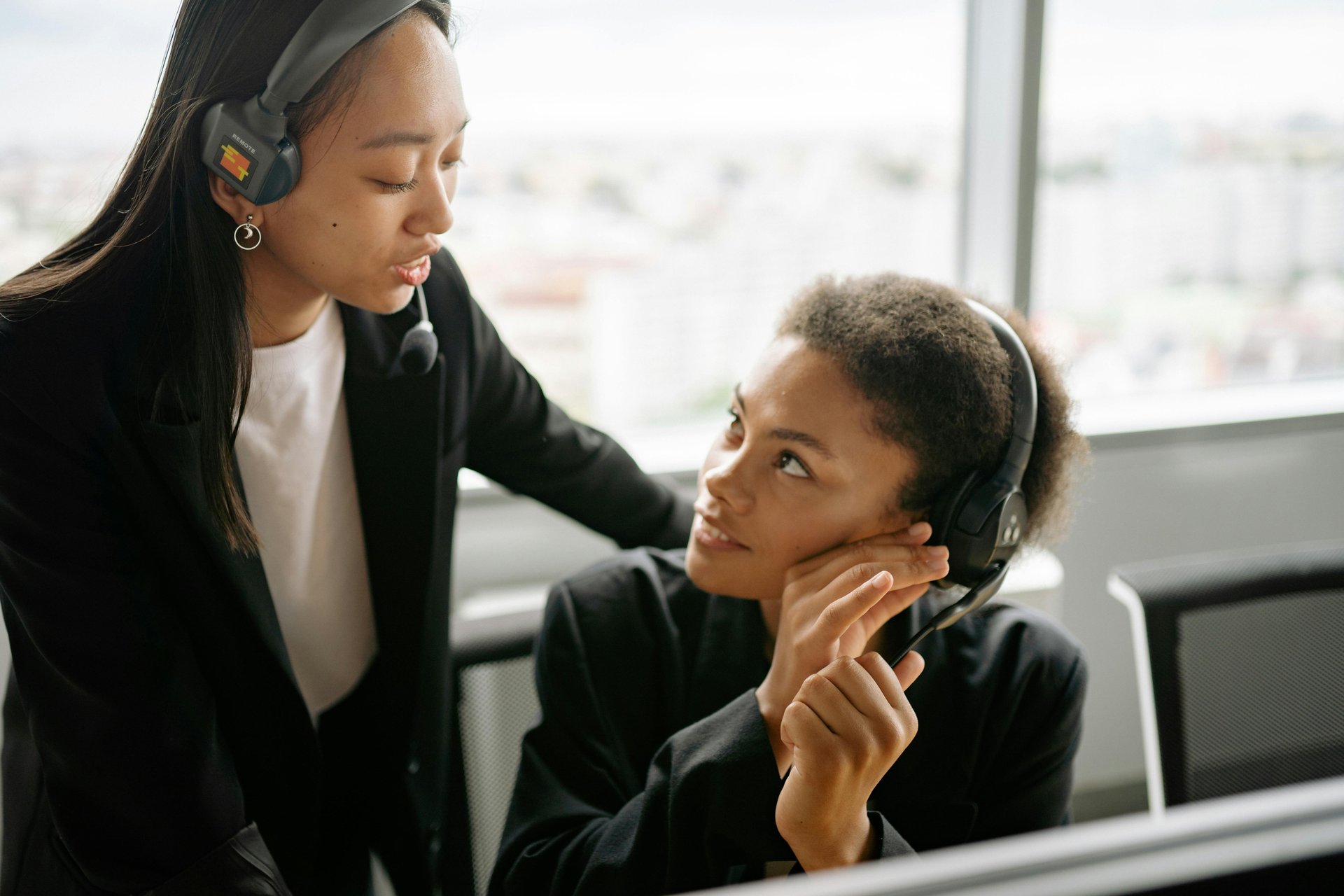 Two call centre agents with headsets managing NDIS complaints and resolving issues