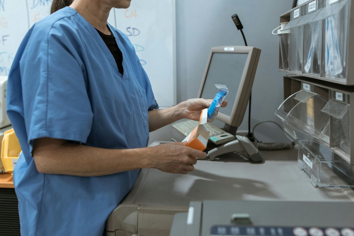 Healthcare professional organising pharmaceutical medication in a medical facility