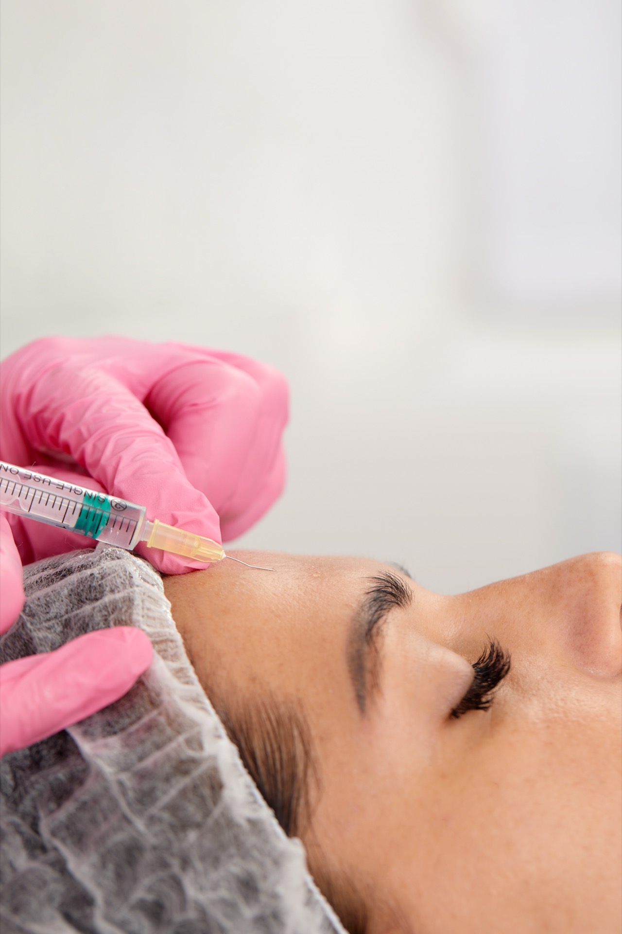 Patient receiving cosmetic botox treatment from a qualified practitioner