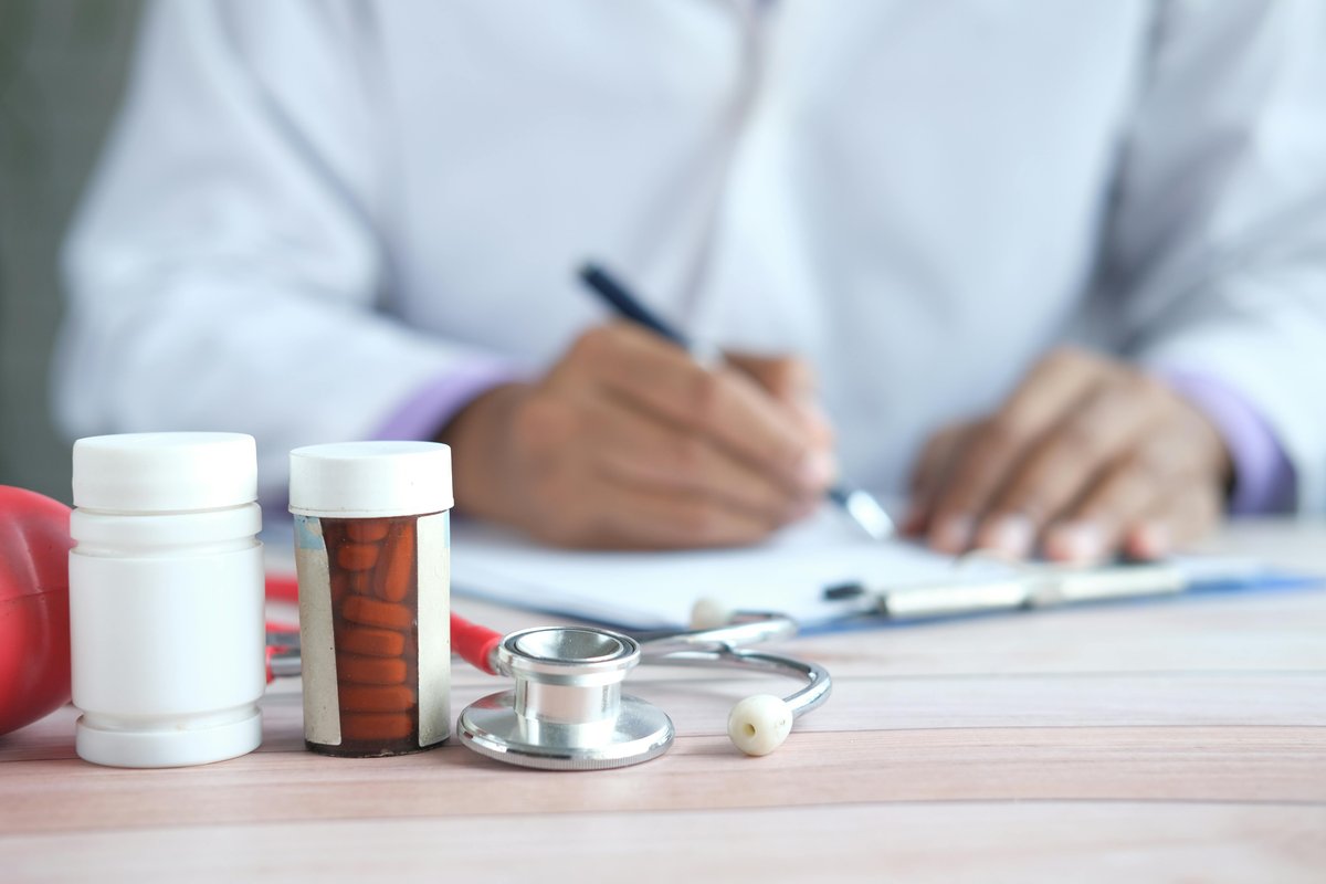 Doctor reviewing medical compliance documentation and prescription records for TGA-regulated weight loss treatments