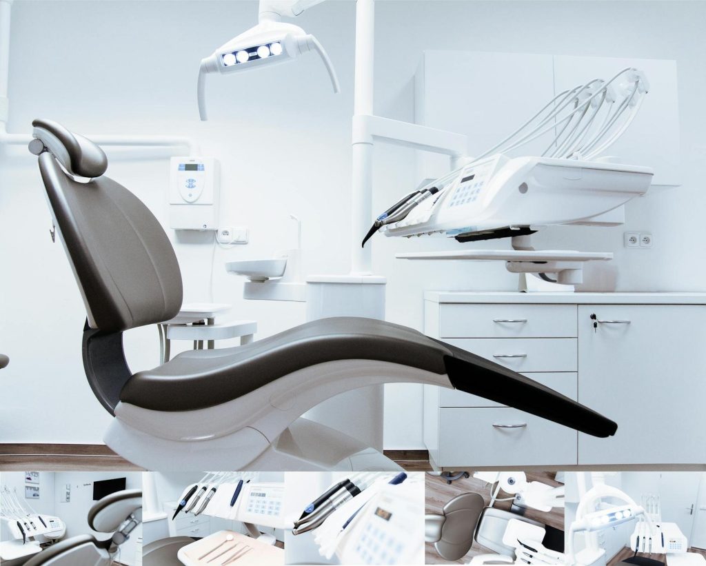 A modern dental office with an empty dental chair, overhead light, and various dental instruments in a clean, white environment.