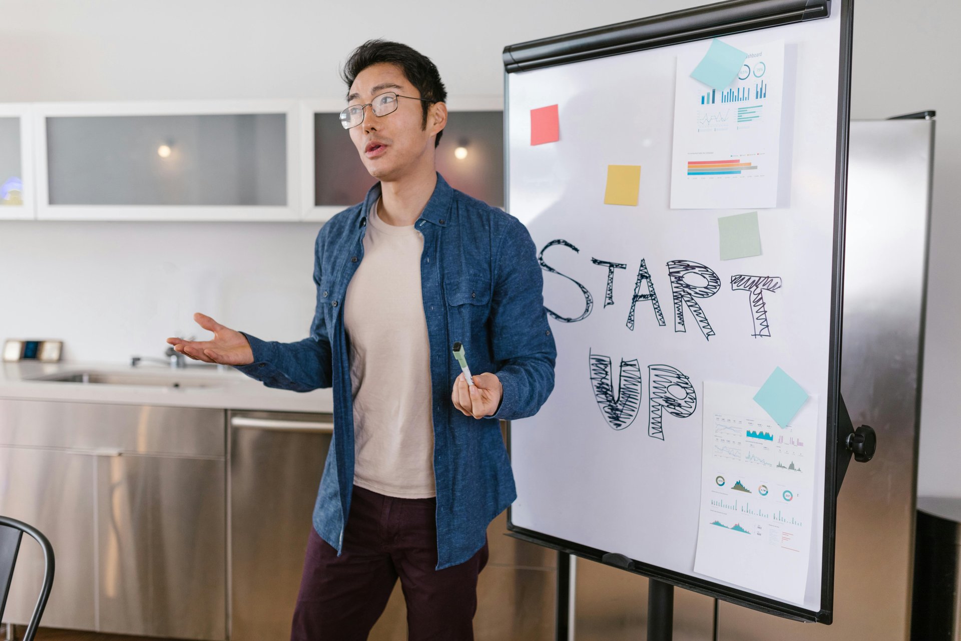 Businessman presenting startup plan with charts on a whiteboard, representing NDIS business planning and structure