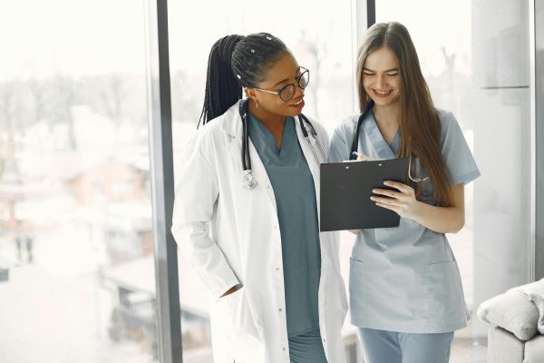 Two female healthcare professionals reviewing NDIS reportable incident documentation